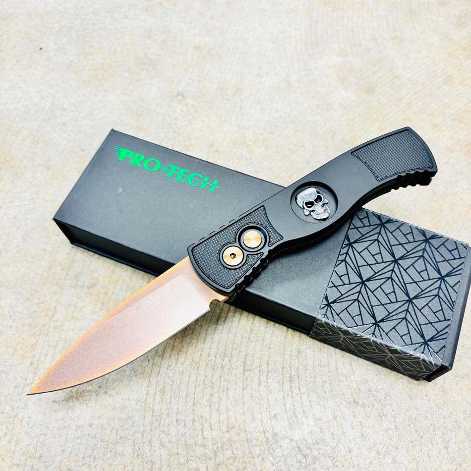 PROTECH TR-2 RG Skull Drop Point 3.0" Rose Gold Magnacut Blade Auto Textured Black Handle with Sterling Silver Shaw Skull Knife PROTECH TR-2 RG Skull Drop Point 3.0" Rose Gold Magnacut Blade Auto Textured Black Handle with Sterling Silver Shaw Skull Knife